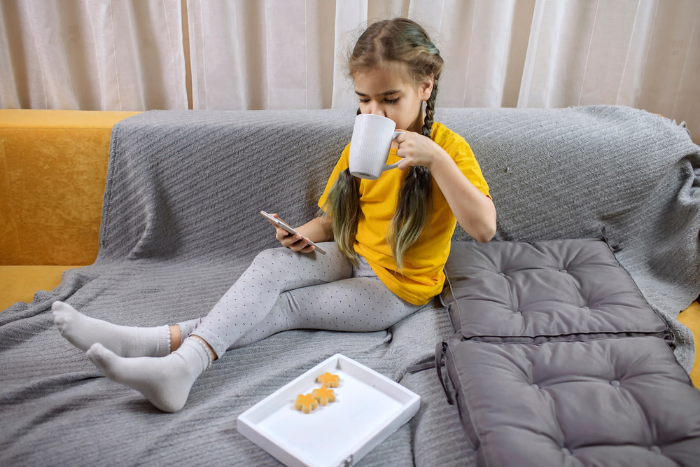 Digital,Native,Generation,Alpha,,Cute,Kid,Lying,On,Yellow,Sofa