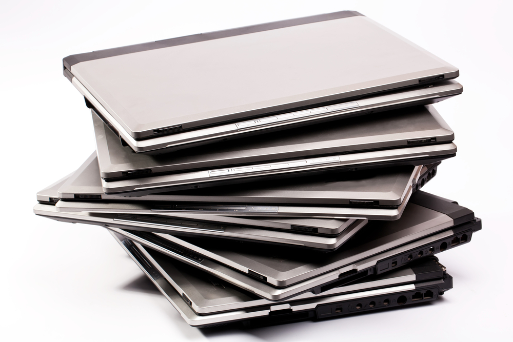Pile,Of,Laptops,On,The,White,Background